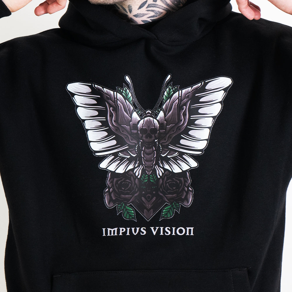 A close up image of the impius death moth on a black hoodie