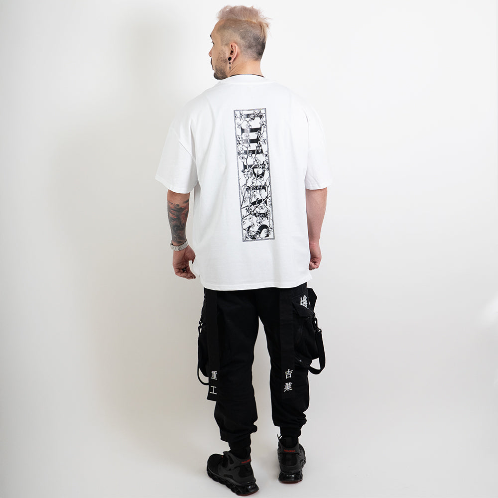 A full body shot of an alternative model wearing a white oversized tee with the impius cherry blossom back design