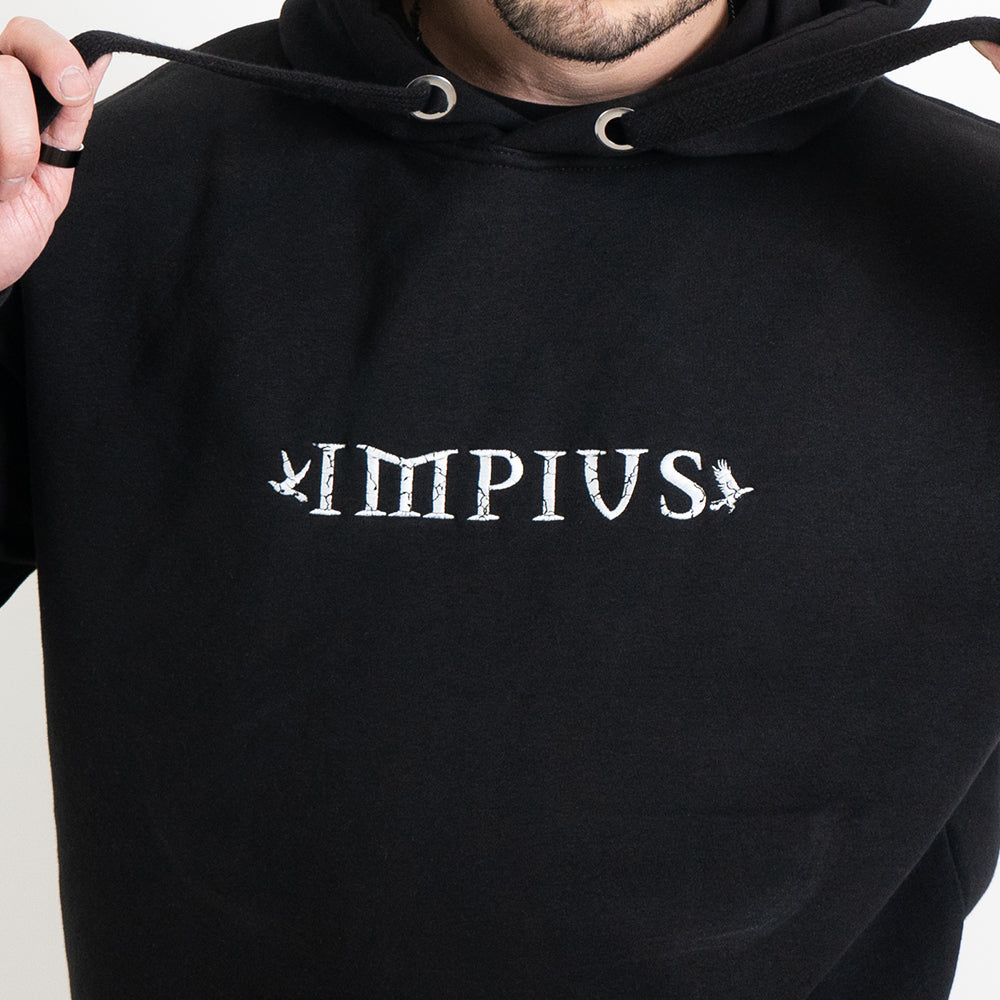 A close up image of the Impius logo on a black hoodie