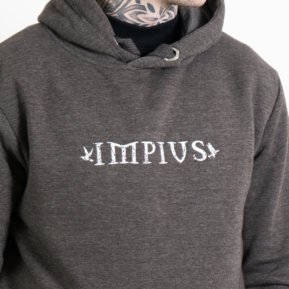 A close up image of the Impius logo on a grey hoodie