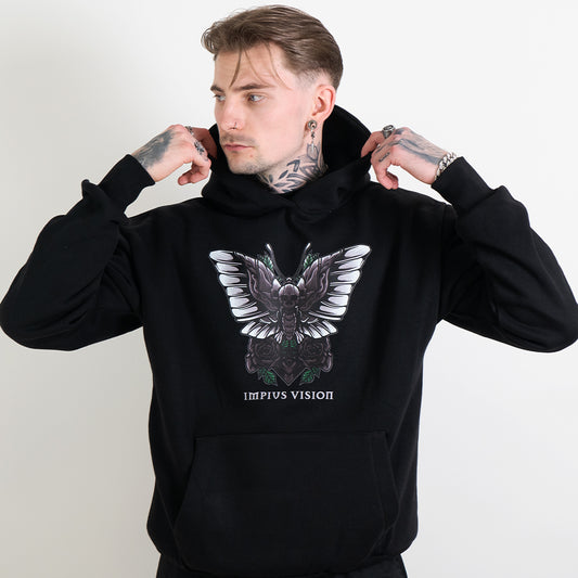 Tattooed model wearing a black hoodie with the impius death moth design