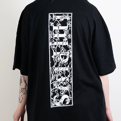 A close up shot of the impius cherry blossom back design on a black oversized tee