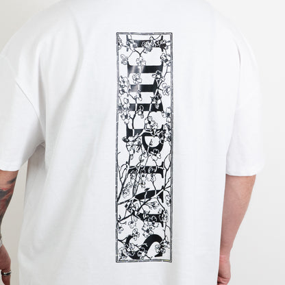 A close up shot of the impius cherry blossom back design on a white oversized tee