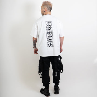 A full body shot of an alternative model wearing a white oversized tee with the impius cherry blossom back design