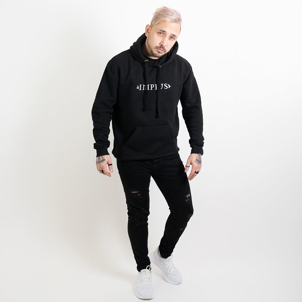 A full body image of alternative model wearing a black hoodie with the Impius logo