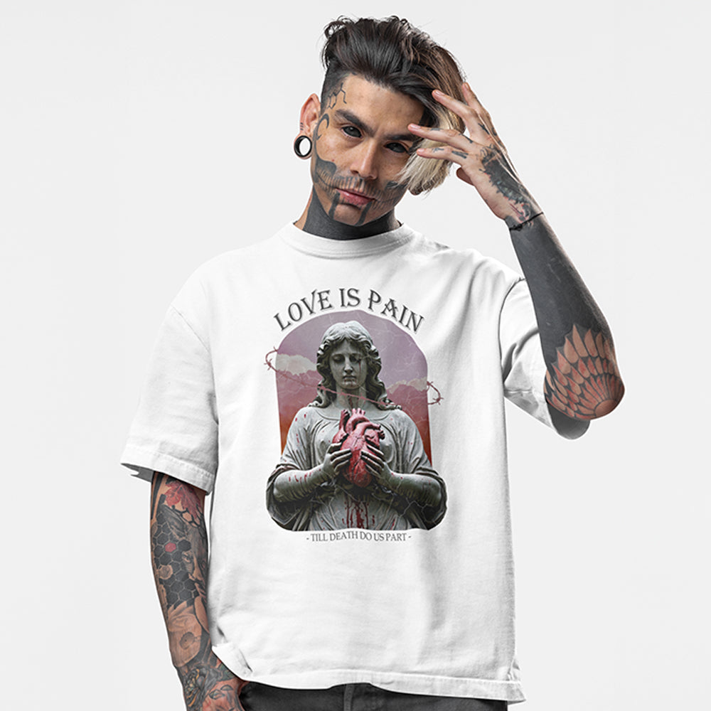 Tattooed model wearing a white oversized tee with the impius love is pain design